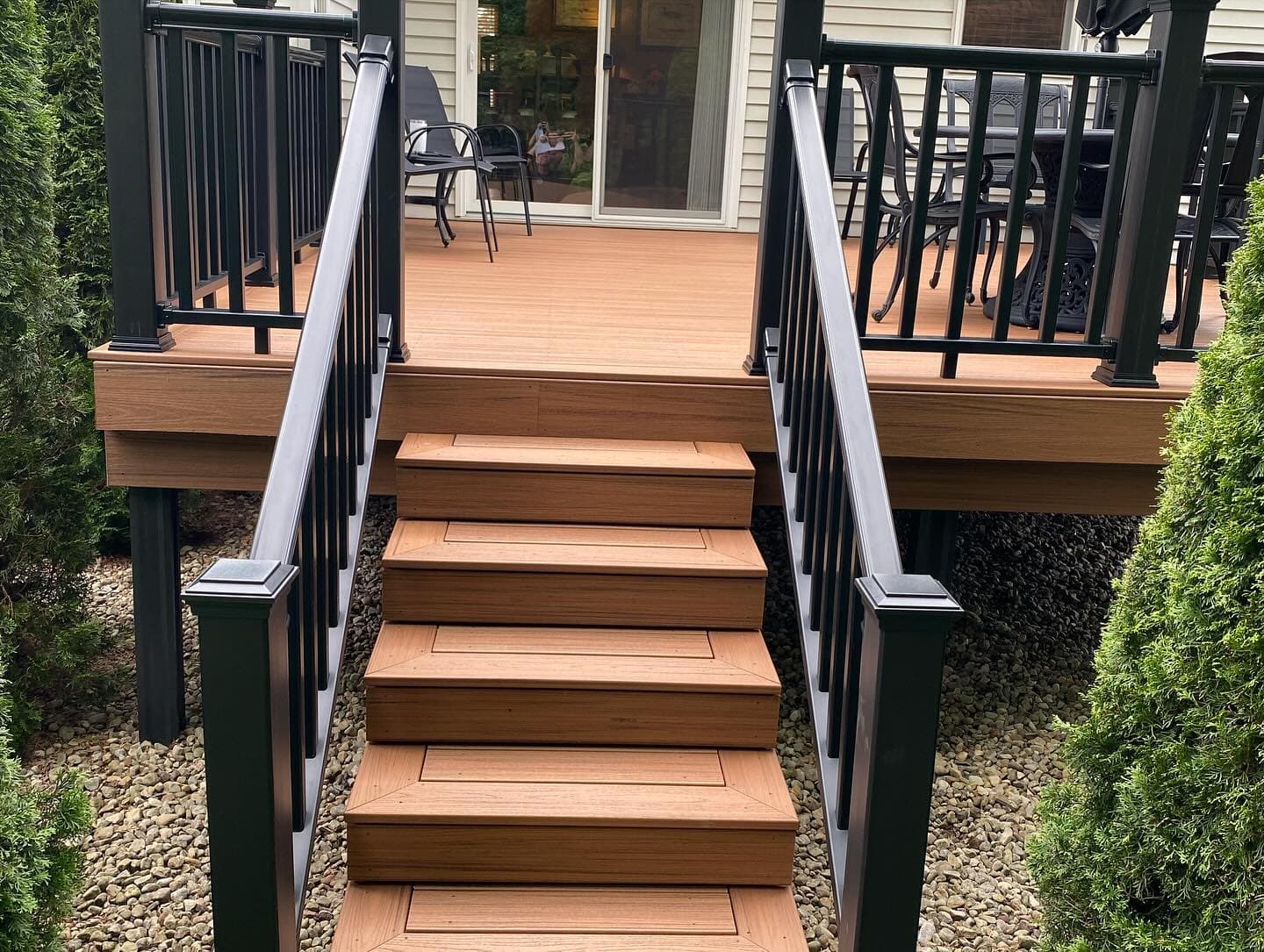 Composite deck stairs with black metal railings