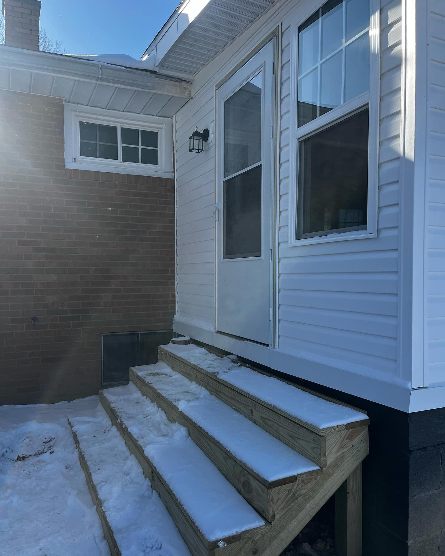 New exterior door and window on brick and siding home