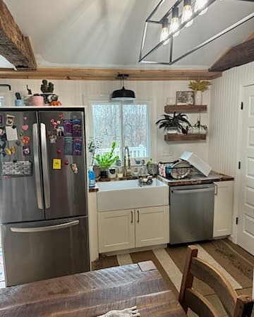 Kitchen with stainless appliances, farmhouse sink, and white cabinets