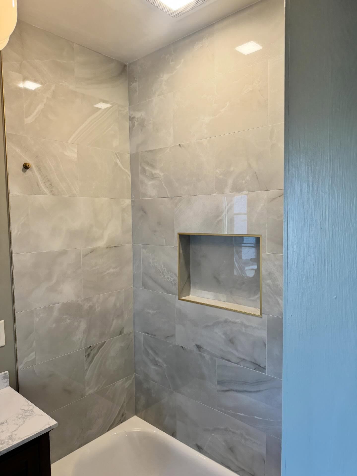 Gray tile shower surround with built-in niche