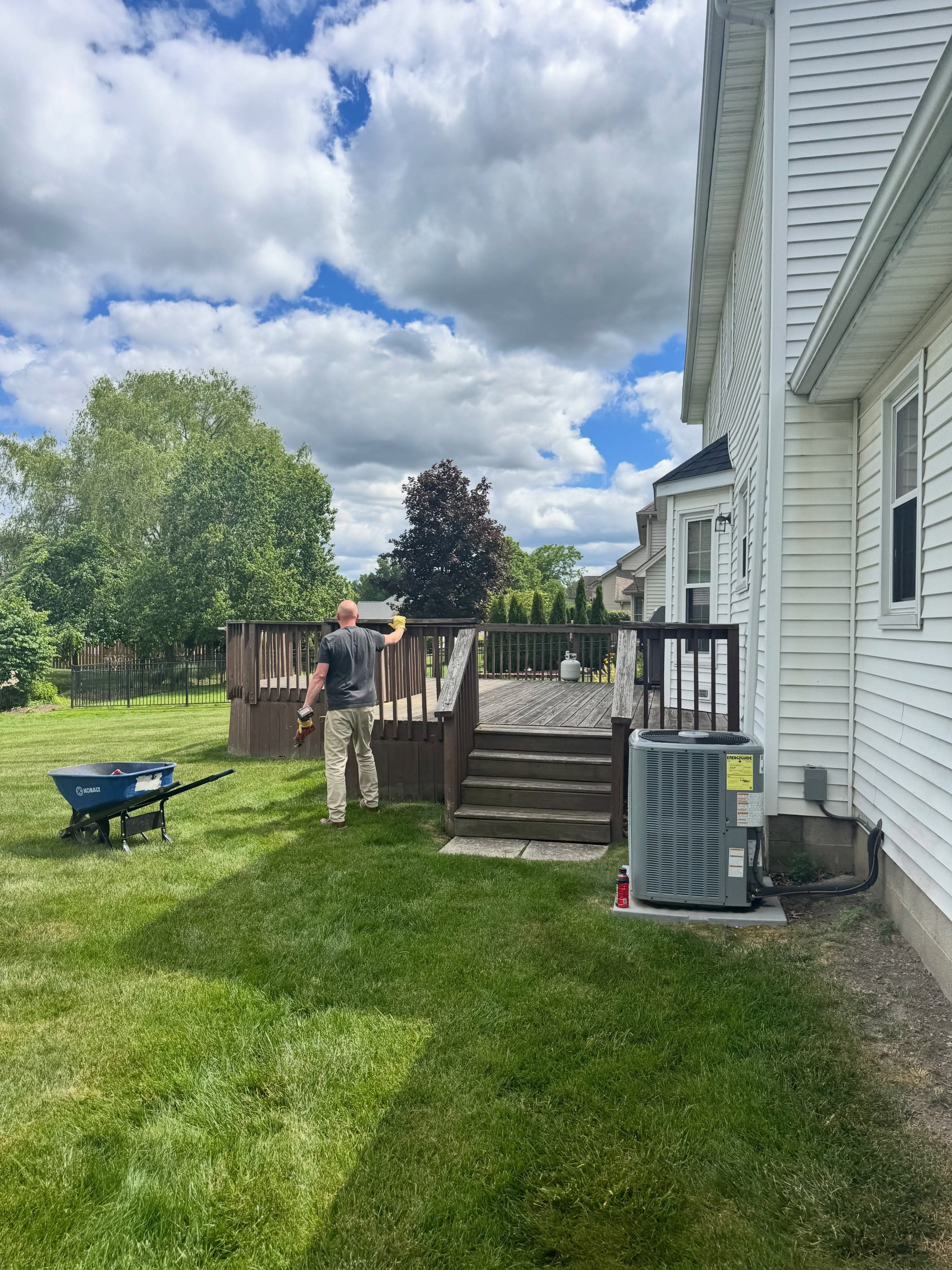 Tom Miller working on a deck railing at a job site